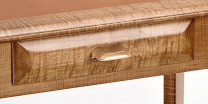 Wooden drawer with a handle on a wooden surface