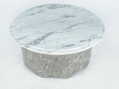 Round marble coffee table with a light gray and white pattern on a white background