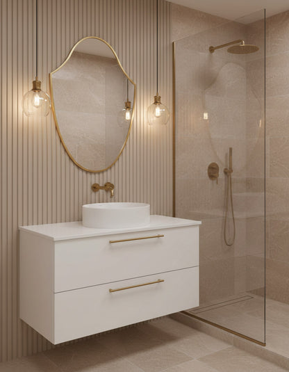 Modern bathroom with white vanity, gold fixtures, and a shower area.
