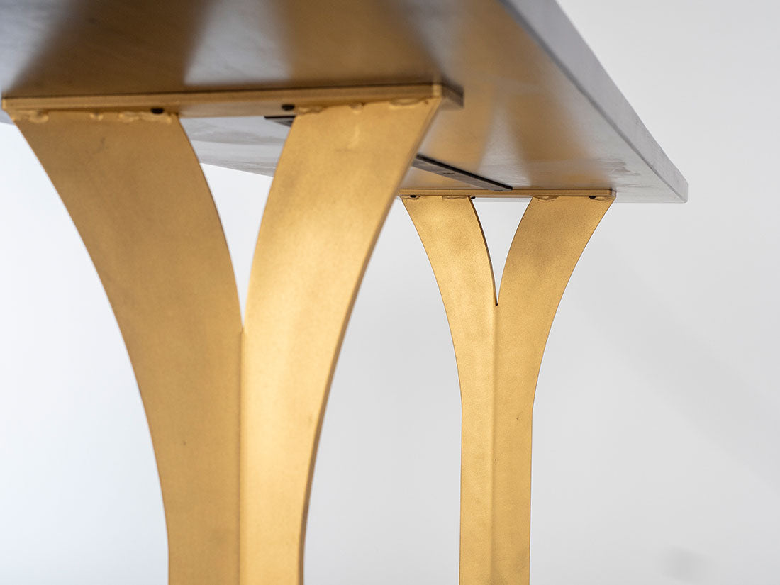 Close-up of a table with gold legs on a white background