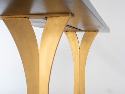 Close-up of a table with gold legs on a white background