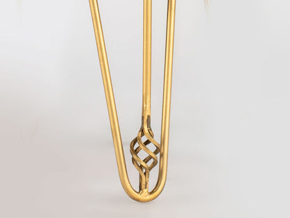 Gold hair clip with intricate design on a light gray background