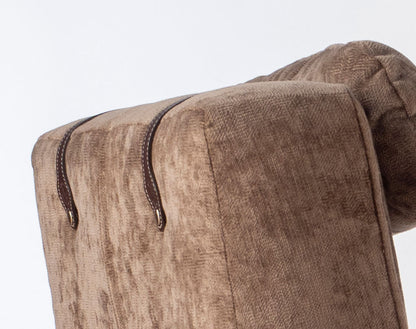 Close-up of a brown textured fabric with leather trim on a white background