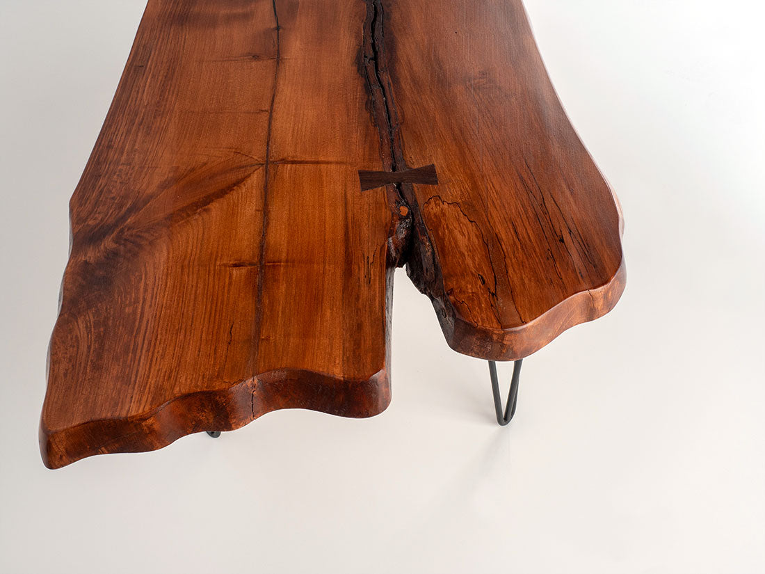 Wooden coffee table with a natural, rustic finish on a white background