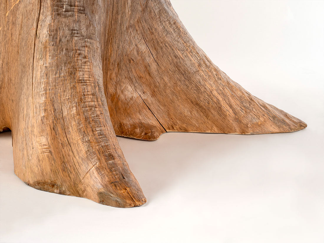 Wooden sculpture resembling a tree stump on a white background
