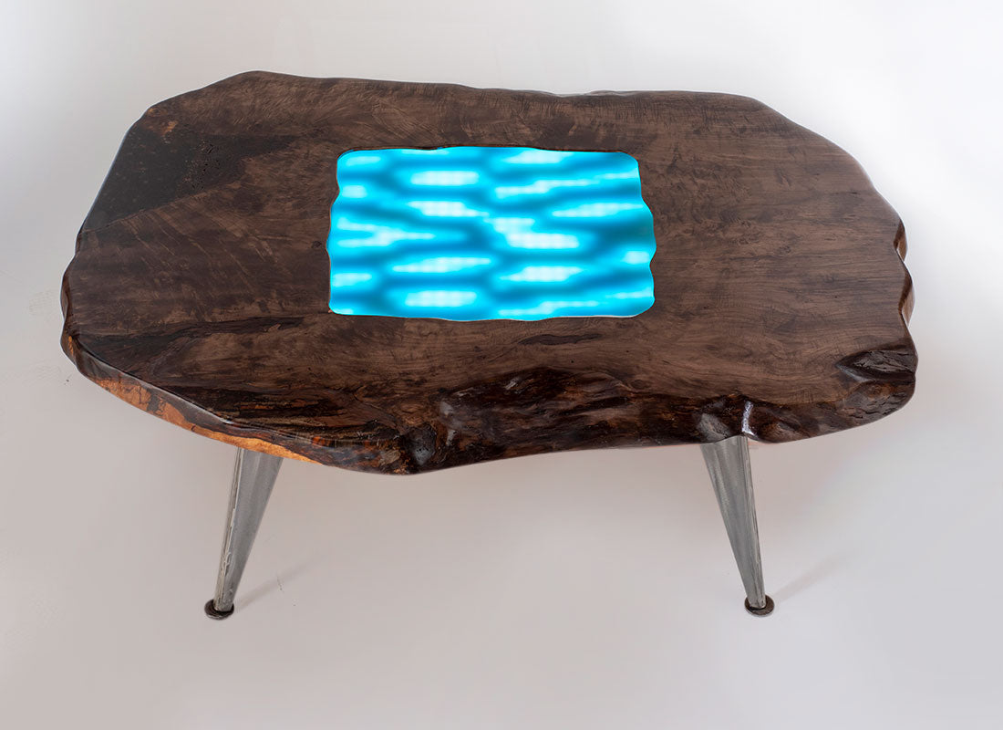 Wooden table with a blue glass inset on a white background