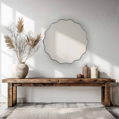 a table with a Wavy Mirrors and vase on it