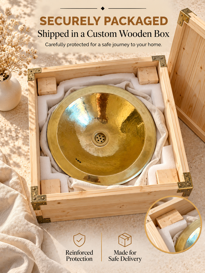 Round hammered brass sink cushioned with foam and fabric inside a wooden shipping box, with text highlighting secure packaging and safe delivery.