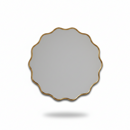 Round mirror with a gold frame on a white background
