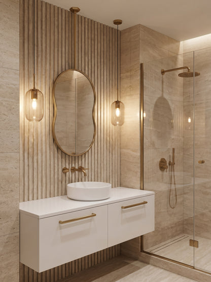 Suspended organic oval brass mirror above a modern bathroom vanity with warm brass fixtures.