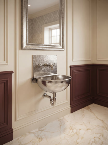 Silver wall-mounted basin with rectangular backsplash and matching faucet in a cream and burgundy paneled bathroom beneath a silver-framed mirror.