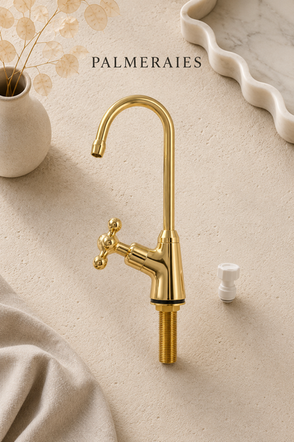Handmade unlacquered brass single-hole kitchen faucet with a classic cross handle, high-arc gooseneck spout, and included installation adapter displayed on a neutral background.