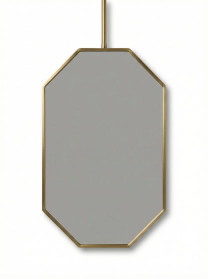 Suspended octagonal brass mirror isolated on white background
