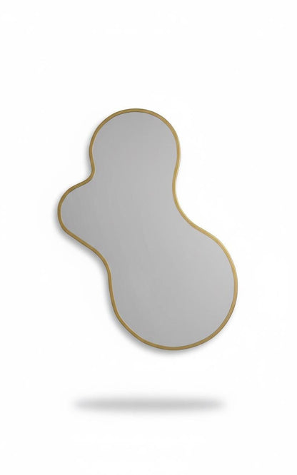 Handmade amoeba-shaped brass mirror isolated on white background