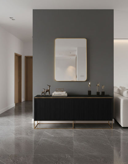 Rectangular brass mirror above modern console table.