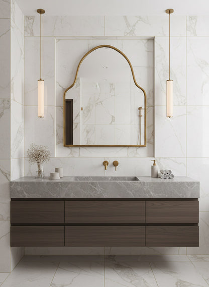 Brass wall mirror above marble vanity in luxury bathroom