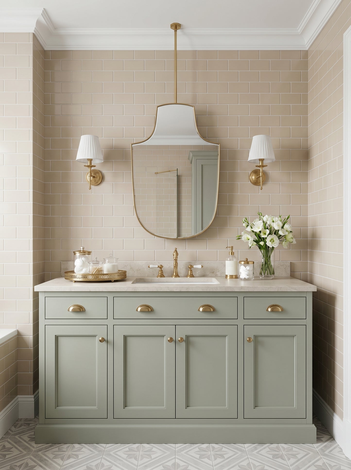 Custom ceiling mounted brass mirror styled with soft green cabinetry, white flowers, and brass sconces.