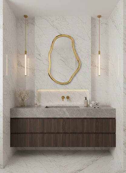 Irregular brass mirror over modern marble bathroom vanity