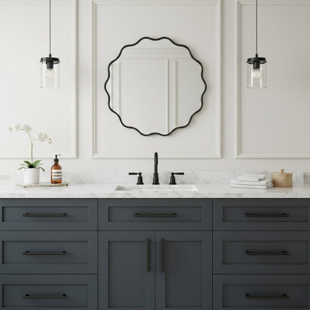 Round wavy black wall mirror over gray vanity in modern white bathroom.