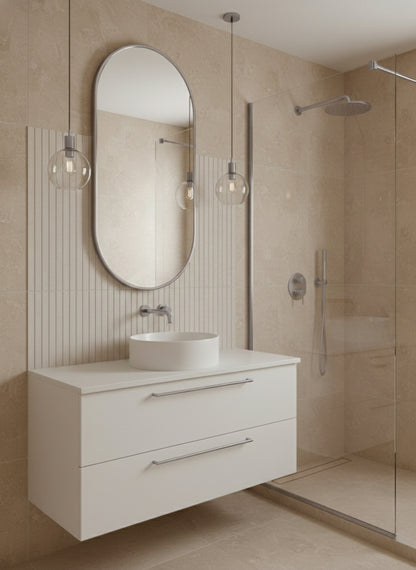 Silver capsule mirror above white vanity in modern beige bathroom.