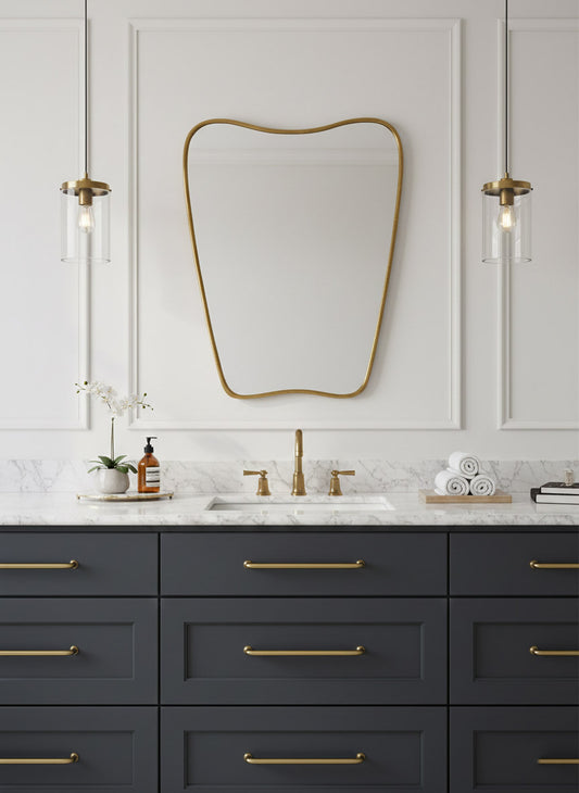 Italian curved brass mirror centered above navy bathroom vanity