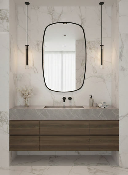 Brass mirror above bathroom vanity