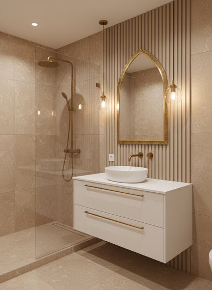 Brass arch mirror above white vanity in modern beige bathroom