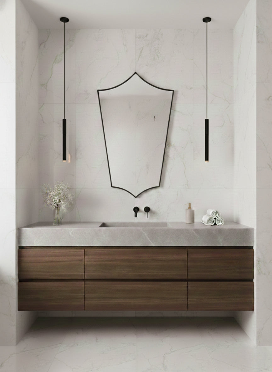 Brass mirror above bathroom vanity