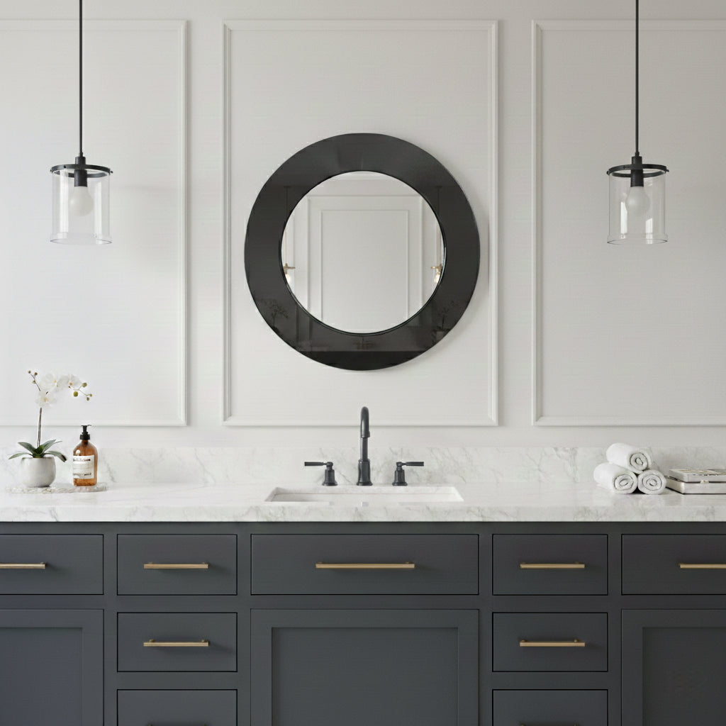 Round black framed mirror above dark blue vanity.