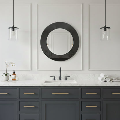 Round black framed mirror above dark blue vanity.