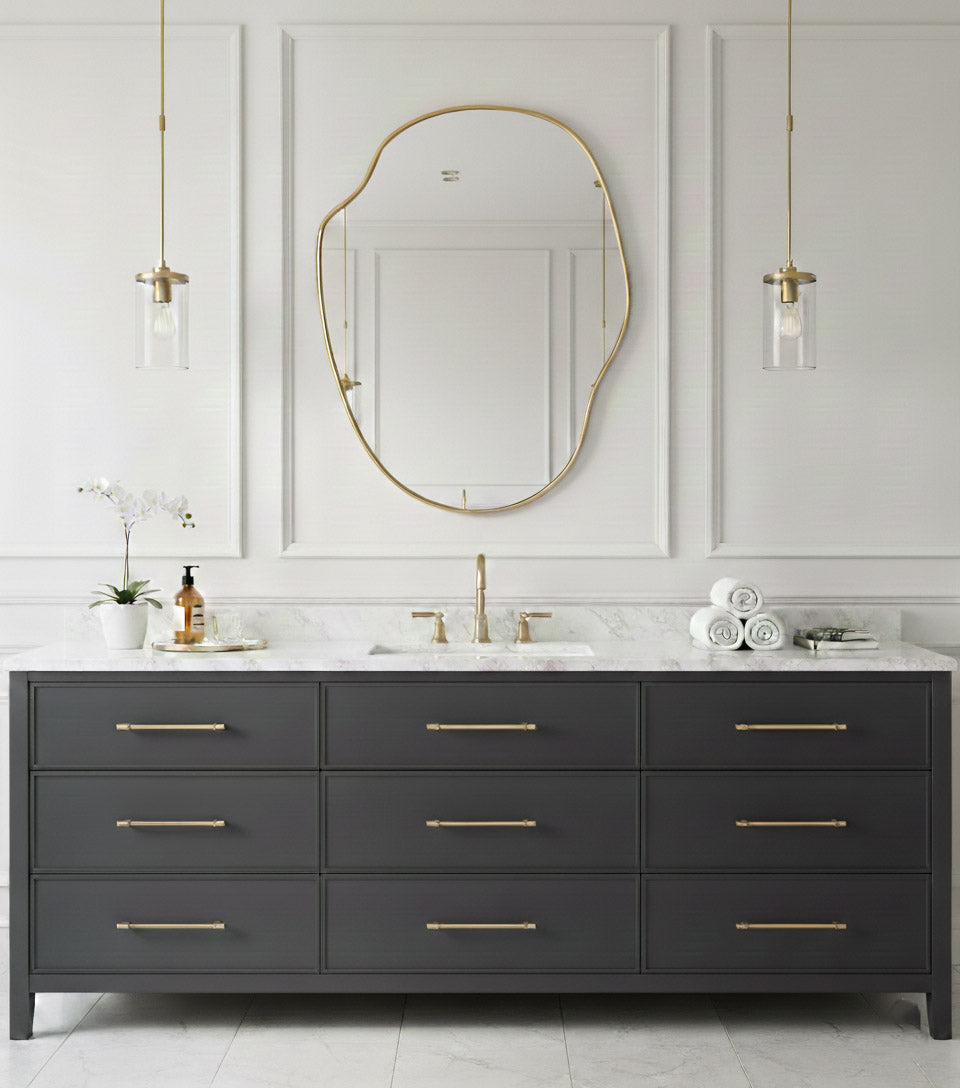 River stone brass mirror above dark gray double bathroom vanity.