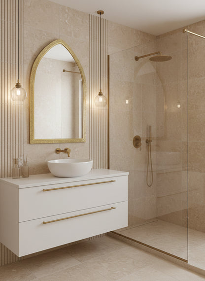 Arch brass mirror above bathroom vanity