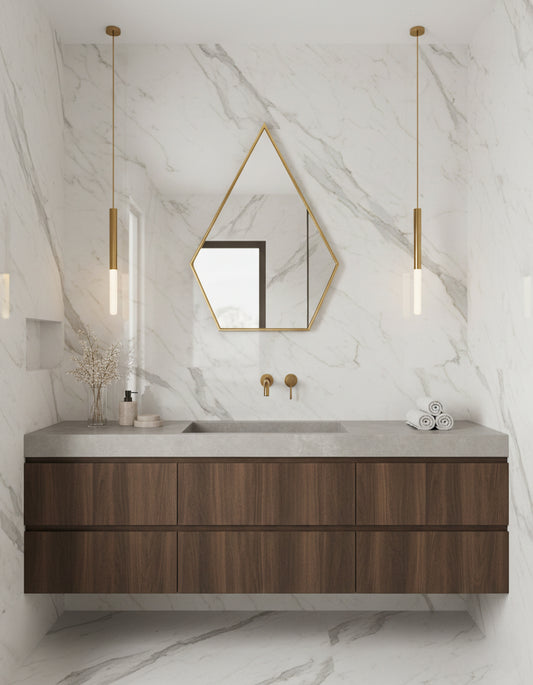 Geometric brass mirror above marble bathroom vanity