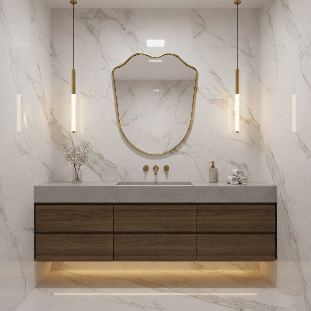 shield  brass vanity mirror in white marble bathroom