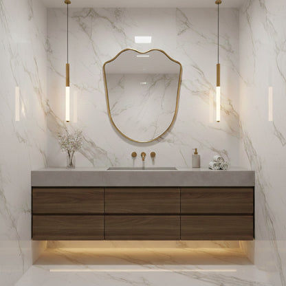 shield  brass vanity mirror in white marble bathroom