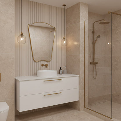 Italian style irregular brass mirror above floating white bathroom vanity