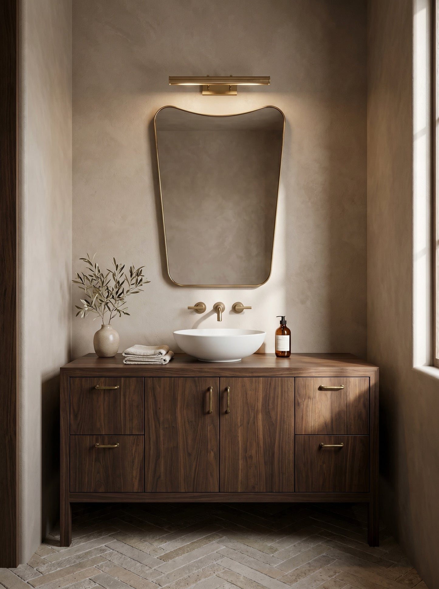 Modern brass wall mirror above walnut bathroom vanity