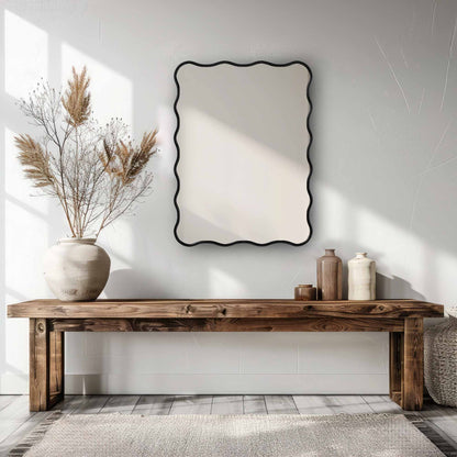 a wooden table with a Wavy Mirror and vase on top of it