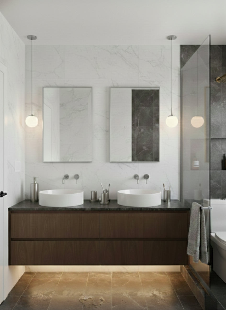 Rectangular wall mirrors above double bathroom vanity.
