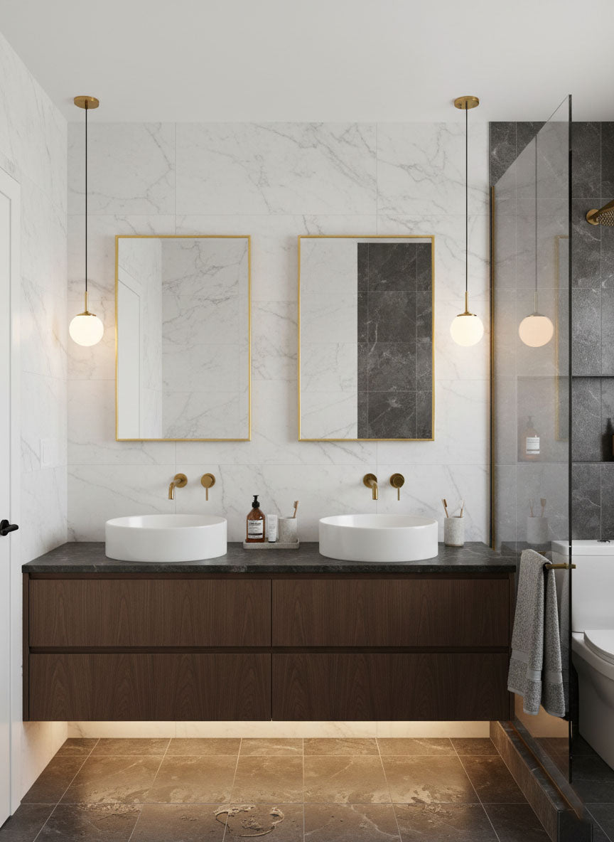 Pair of triangle brass mirrors above double sink vanity