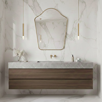 Arched top brass mirror above floating wood vanity on marble wall