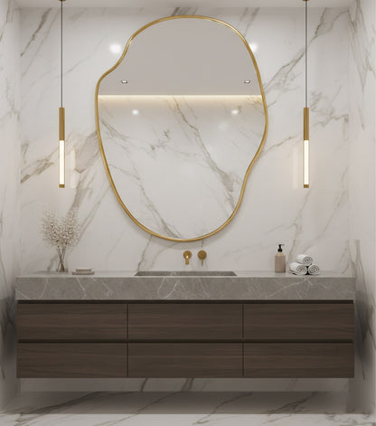 Large river stone brass mirror above marble bathroom vanity.