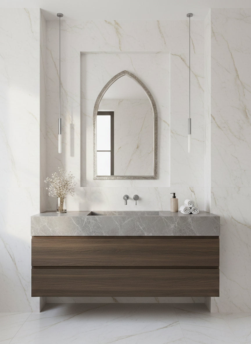 Arch brass mirror in marble bathroom