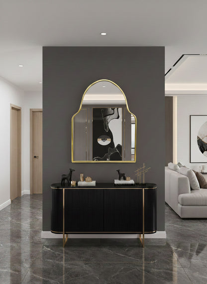 Brass mirror styled above console in contemporary living space