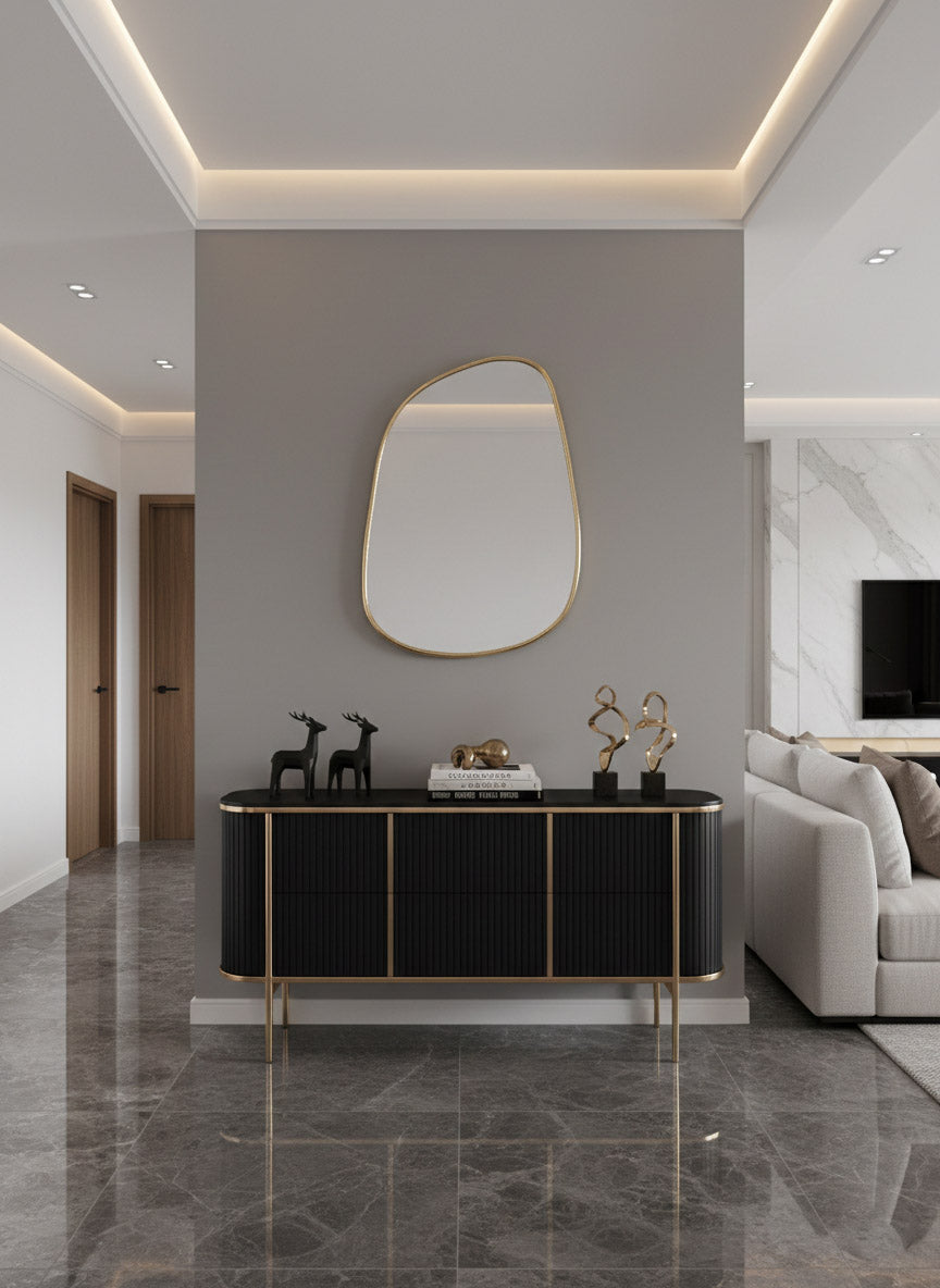 Organic brass wall mirror above black console table