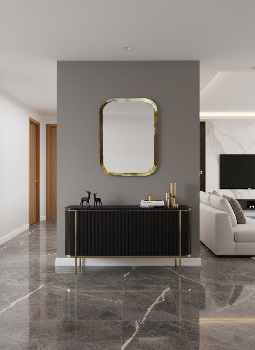 Brass rectangular mirror above black console table