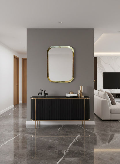 Brass rectangular mirror above black console table