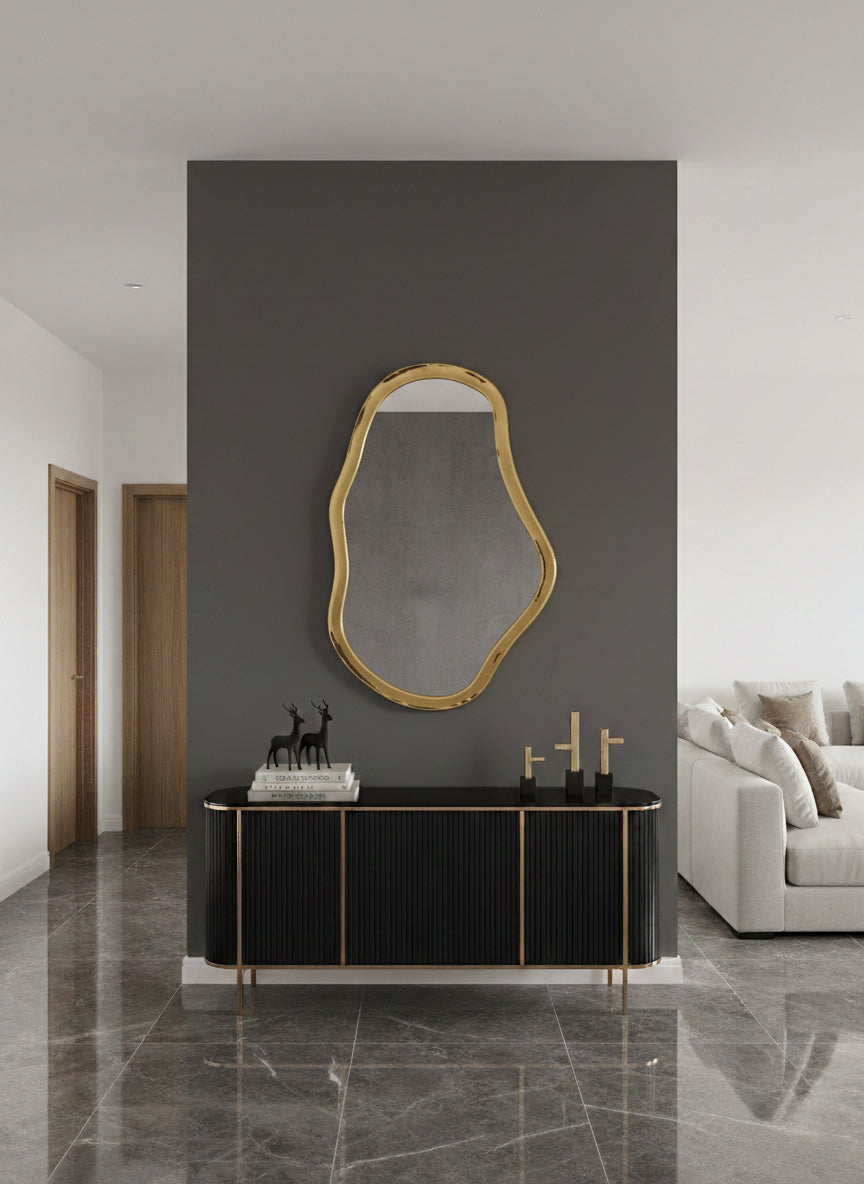  brass mirror styled on dark wall with console