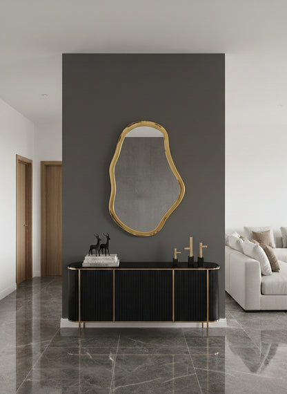  brass mirror styled on dark wall with console
