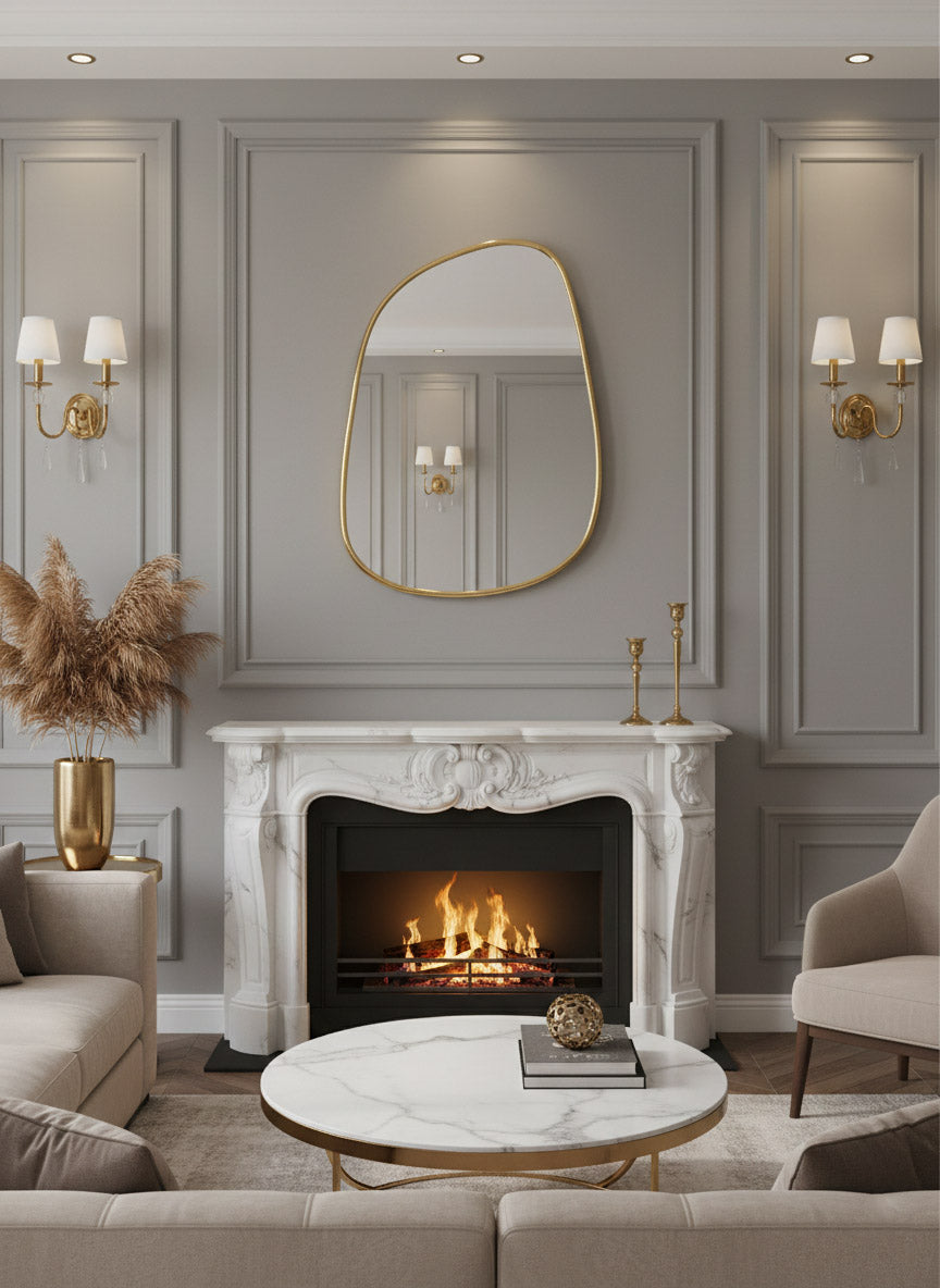 Organic brass wall mirror above marble fireplace mantel